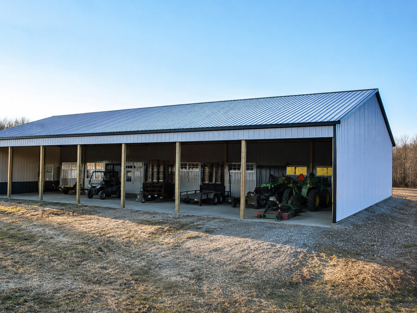 Long open-front equipment shed on a gravel pad