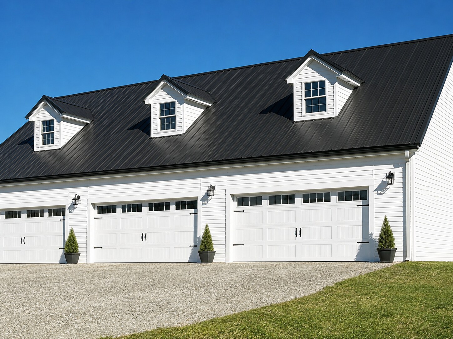 White three-car garage with dormers and white overhead doors