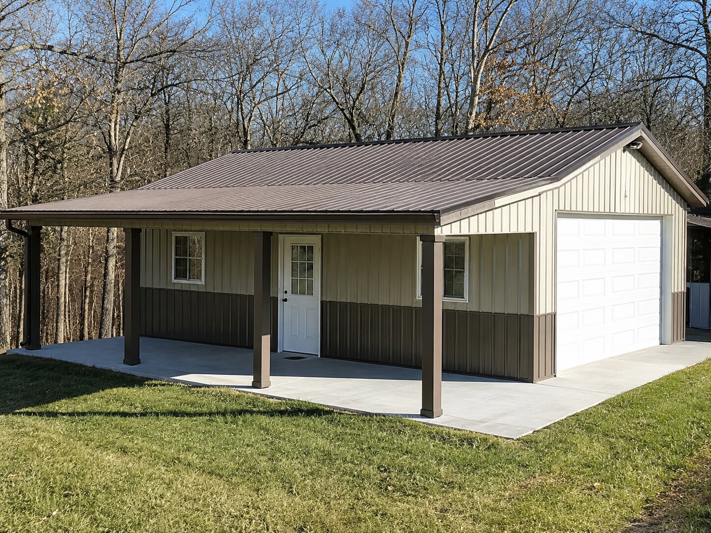 Small post-frame home with covered porch and white overhead door