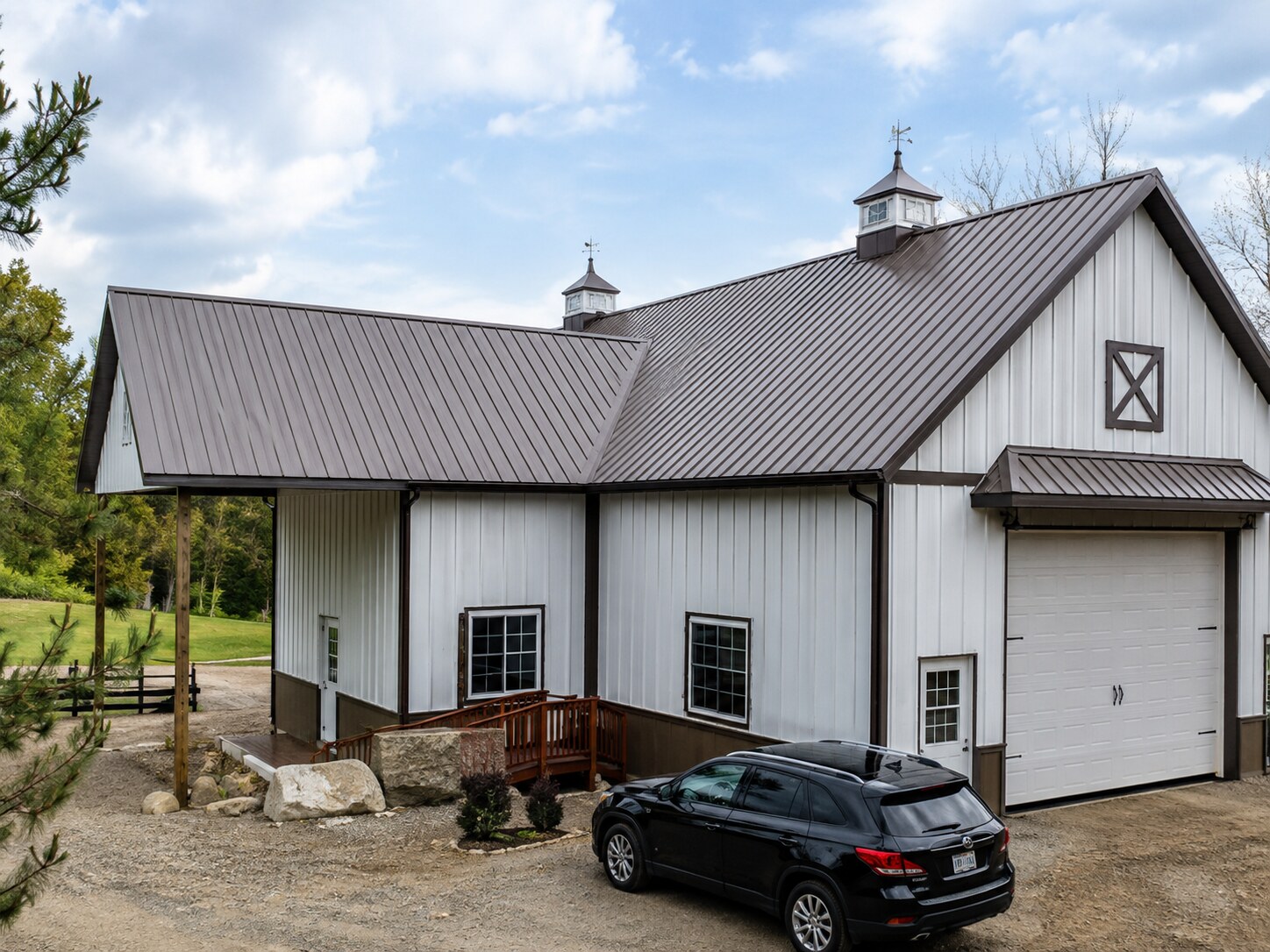 Gray commercial shop with multiple overhead doors and paved lot