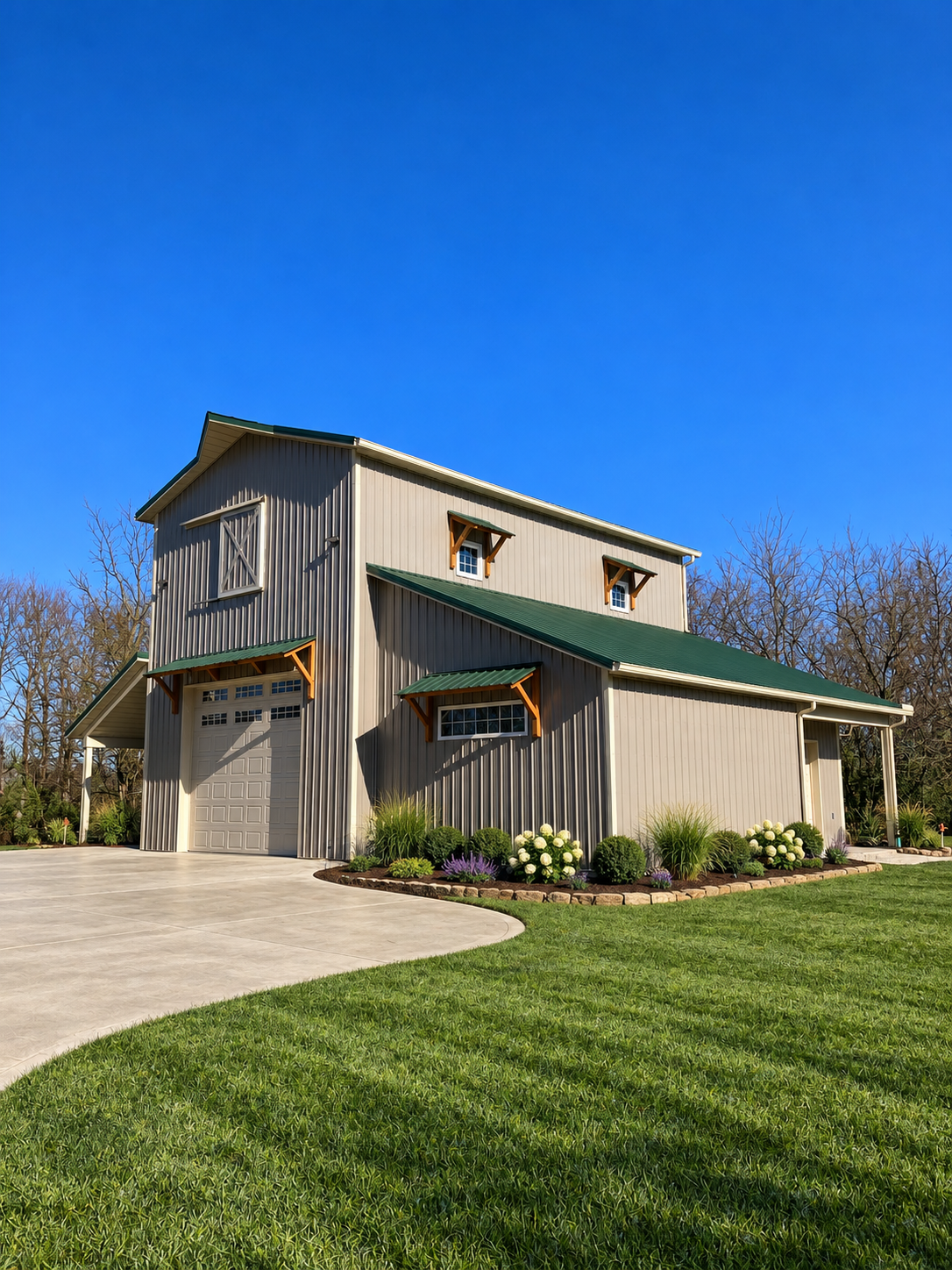Tan monitor-style post-frame home with green metal roof and covered entry