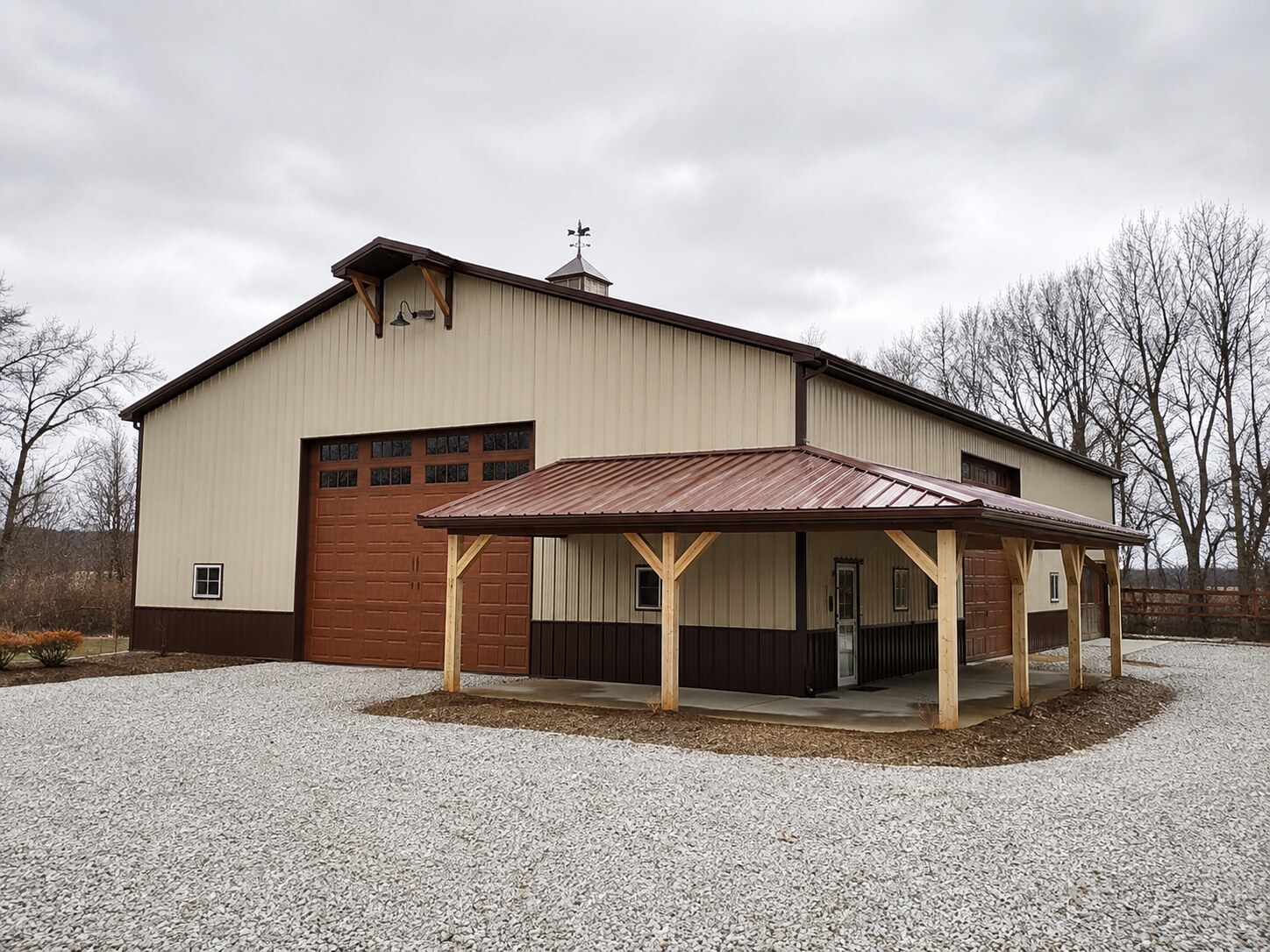 Commercial post-frame building with metal siding and overhead doors